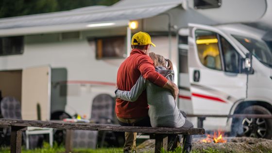 daughter hugging father in front of RV