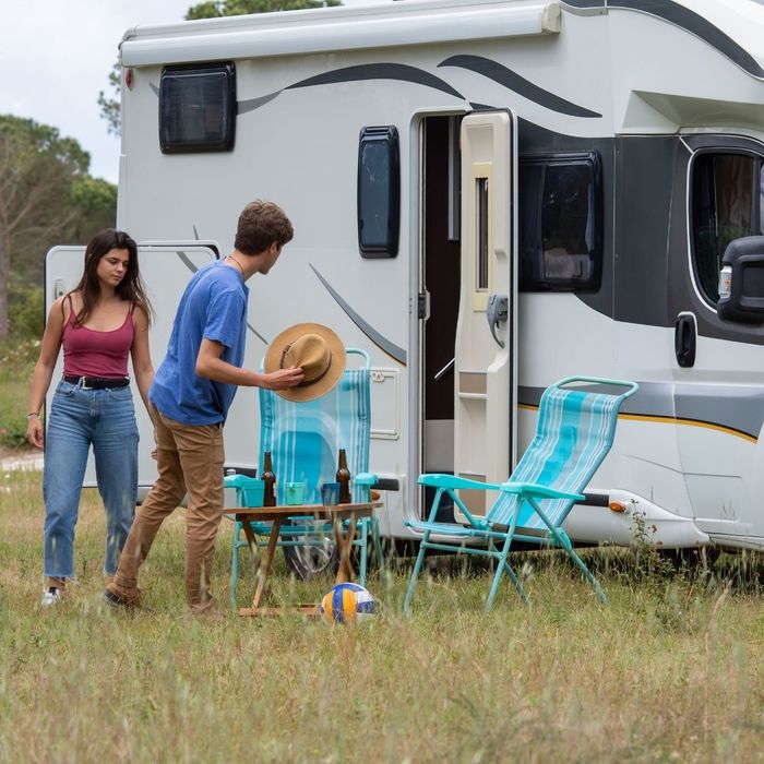 A family enjoying a clean, well-maintained RV at a campsite