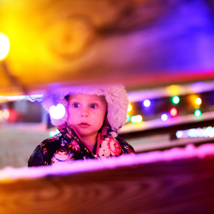 young child looking at Christmas lights. 