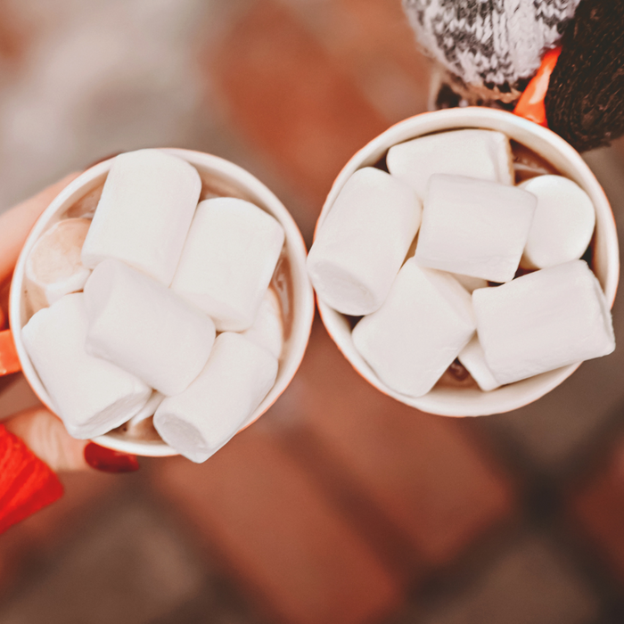 two mugs full of hot cocoa. 