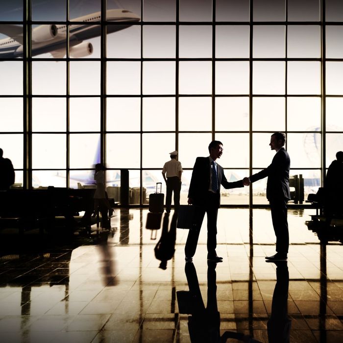 men shaking hands in airport men shaking hands in airport