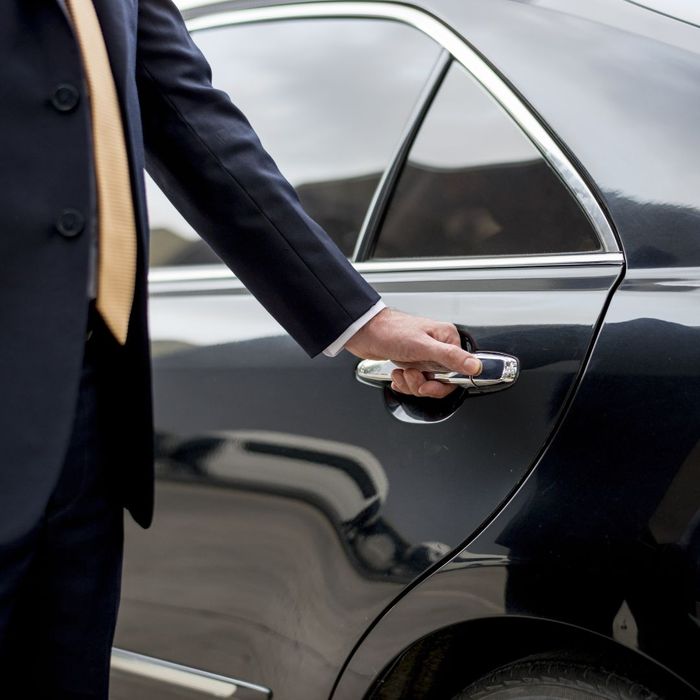 chauffeur opening limo door chauffeur opening limo door