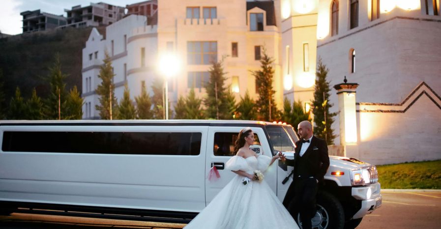 Bride and groom in front of a limo