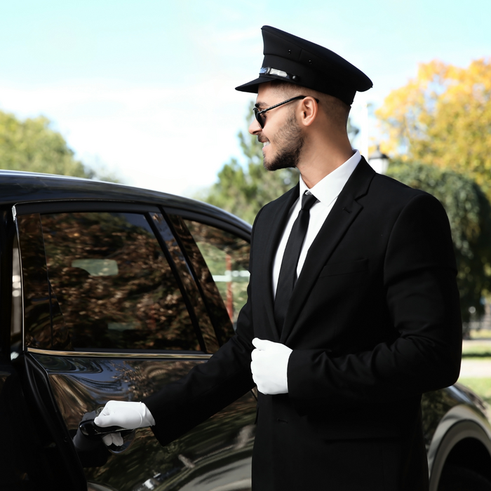 Chauffeur opening the door for his passengers. 