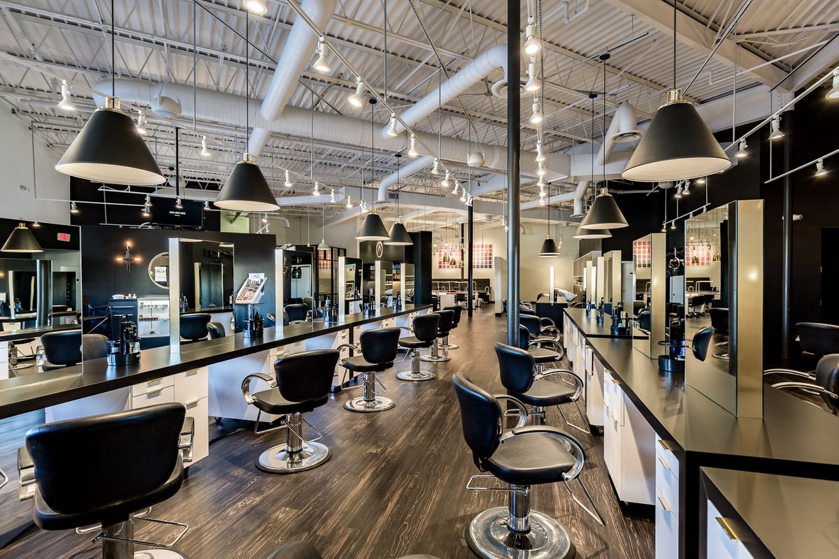 Cosmetology student styling hair at Summit Salon Academy Tampa