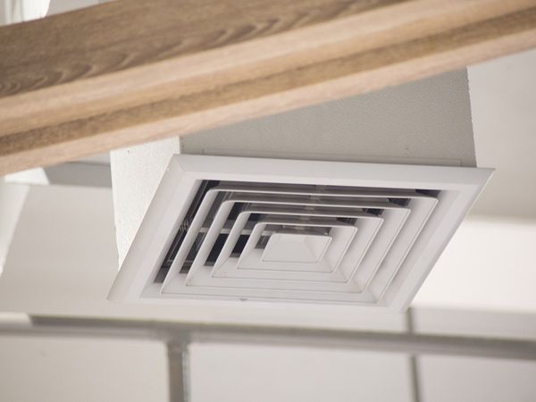 A ceiling air vent in a building. 