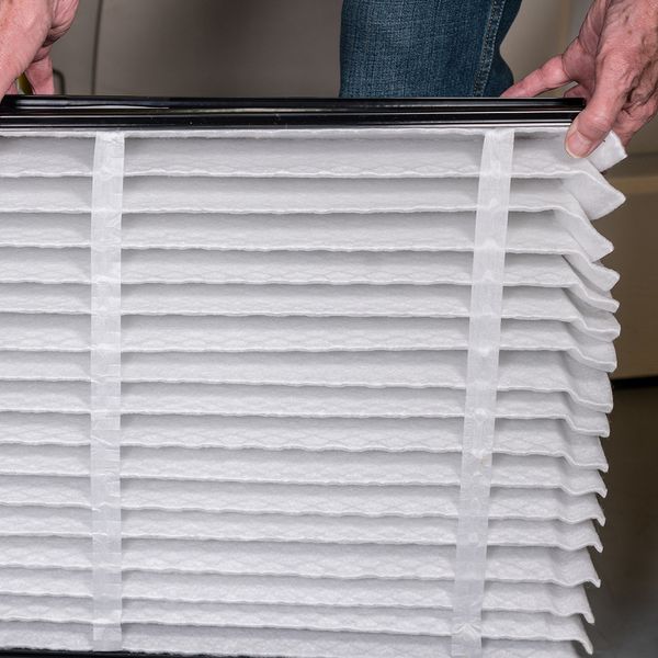 Image of a man installing a clean air filter