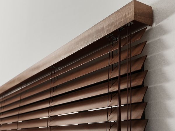 closed brown wood blinds covering window