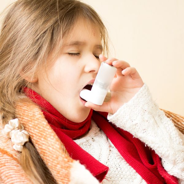 Image of a girl with asthma using and inhaler