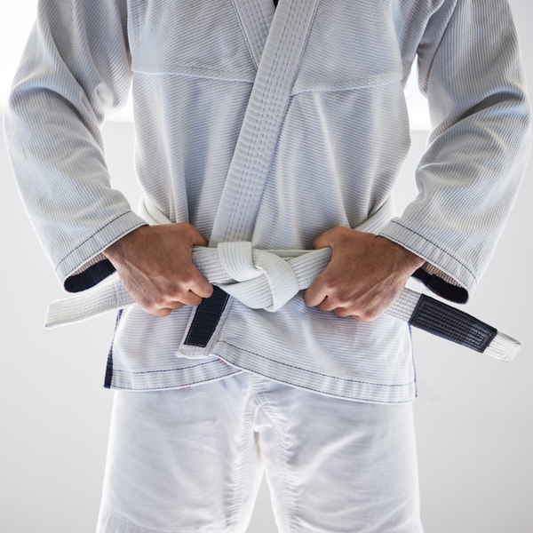 person tying a martial arts belt. 