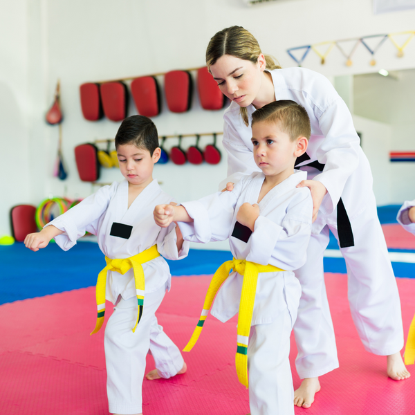 young children being taught martial arts. 