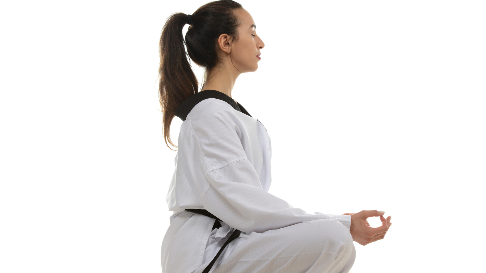 woman in martial arts gear looking peaceful. 