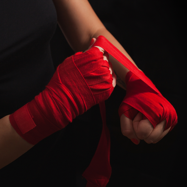 Person putting martial arts ribbon on their hands. 