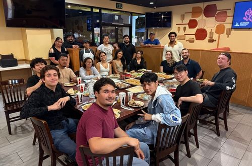 Group of people eating pizza
