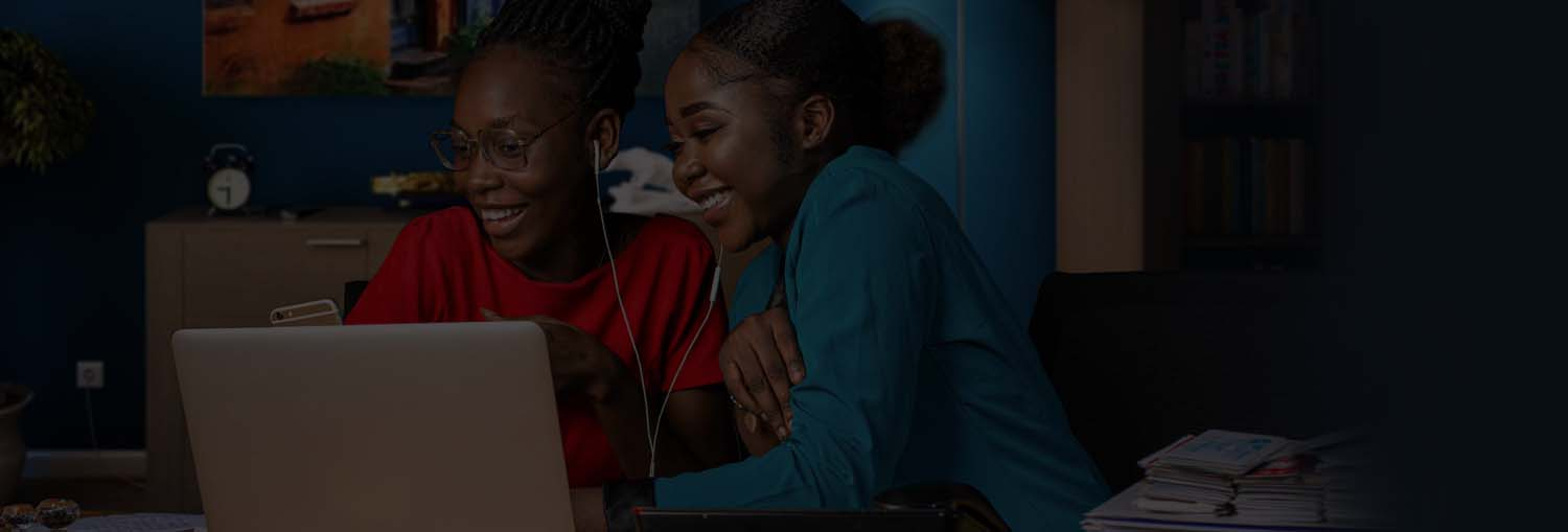 two girls sharing a computer