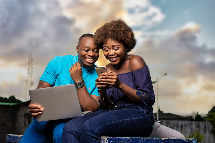 couple using laptop and phone