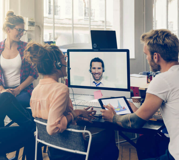 team of workers gathered around a computer