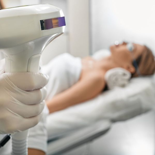 Intense Pulsed Light machine with woman in background