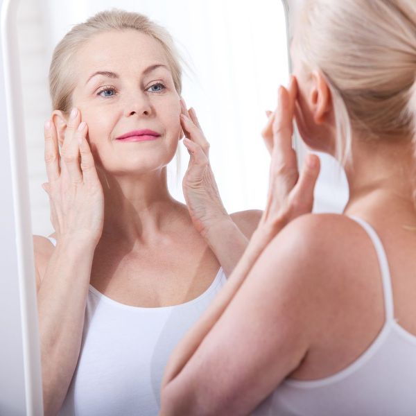 Older woman applying skin cream