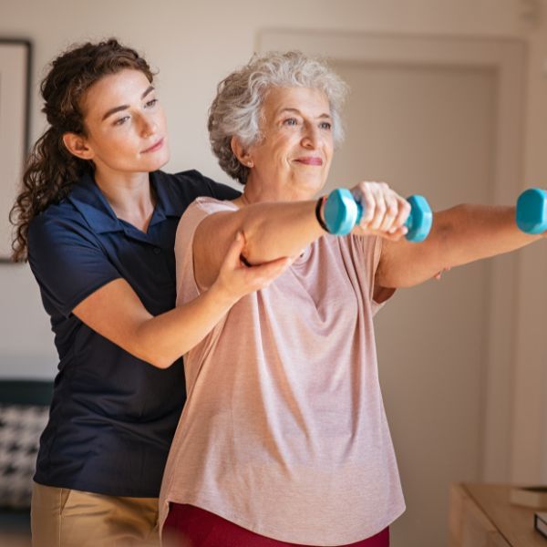 caregiver helping senior with exercise