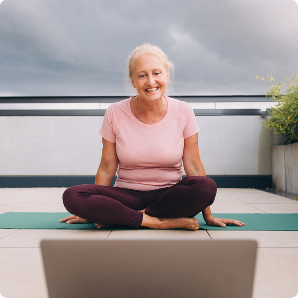 woman sitting with her legs crossed, smiling. 