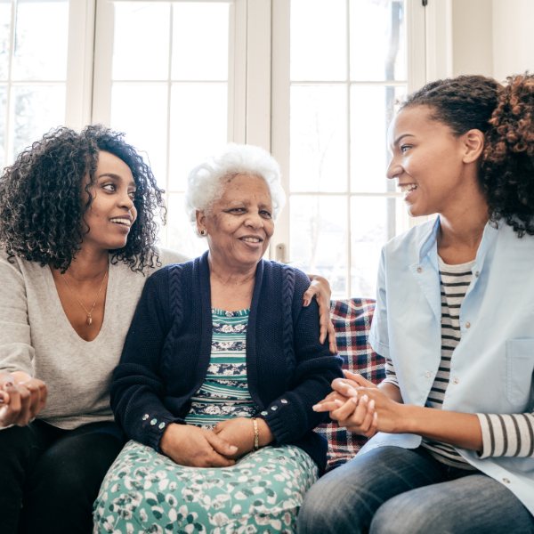 caregiver talking to senior and daughter