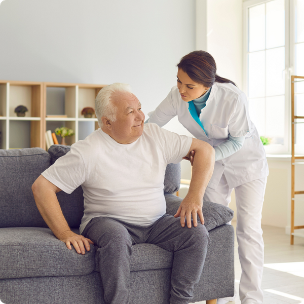 caregiver helping an elderly man.