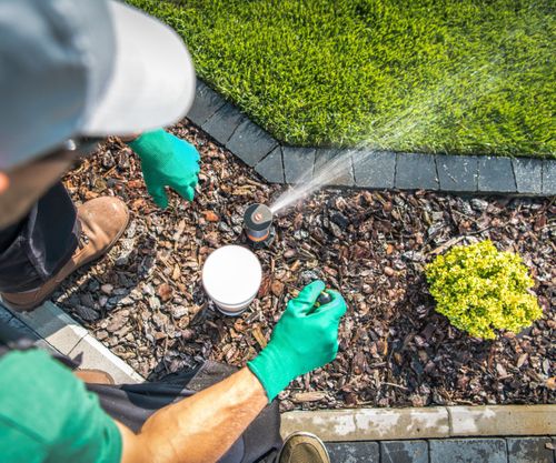 employee working on sprinkler system