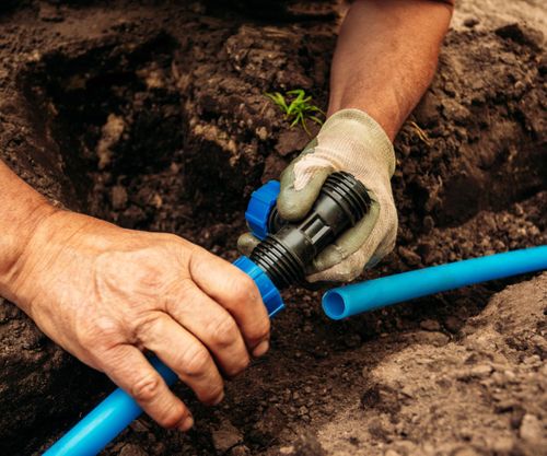 employee working on irrigation piping