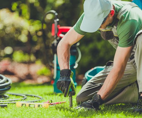 employee working on sprinkler system