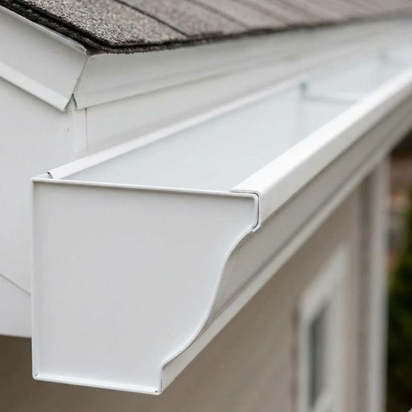 Close-up detail of a white seamless aluminum gutter showing its continuous design.