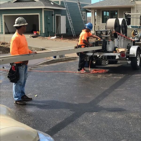 workers fabricating a seamless gutter Seamless Aluminum Gutters Vs. Traditional (3).jpg