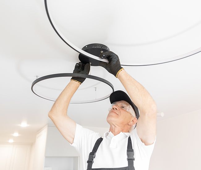 electrician installing lighting in a home