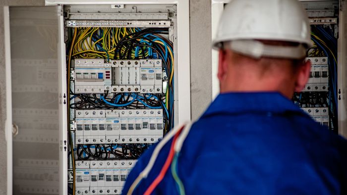 Electrician looking a circuit breakers. 