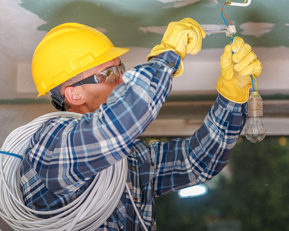 electrician installing wiring in a new home