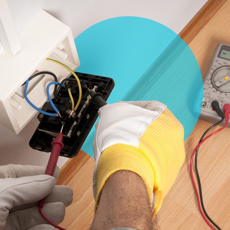 closeup image of an electrician's hands working