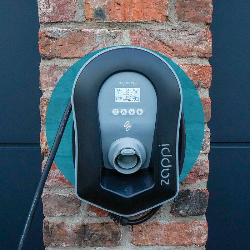 An electric vehicle charging station on the side of a house