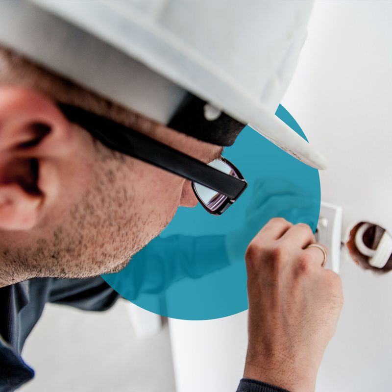 An electrician installing an electrical plug