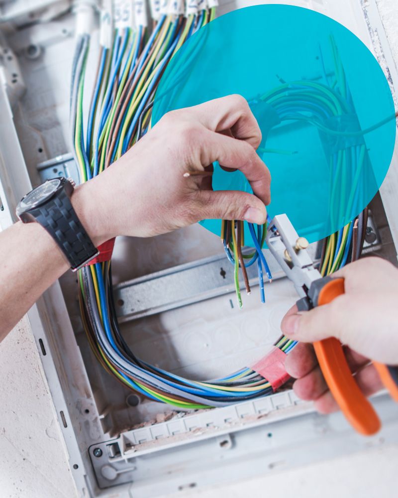 An electrician's hands working on wiring