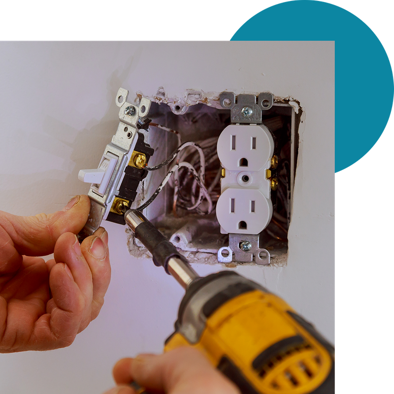 Electrician rewiring electrical outlet