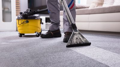person cleaning floor with carpet cleaner