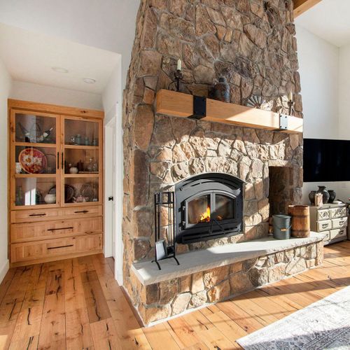 a display cabinet near a fireplace About Us.jpg