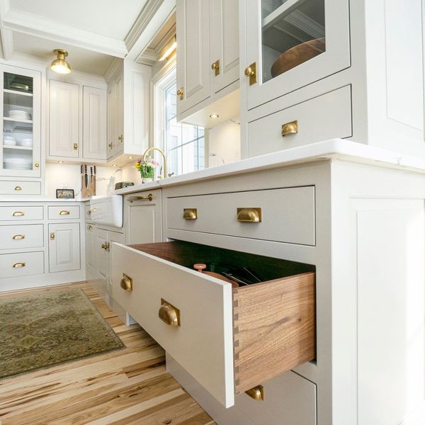 modern white kitchen cabinets with sleek gold handles