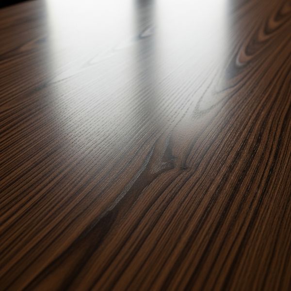 A flawless, highly polished dark walnut tabletop surface reflecting light, showing no scratches or damage.