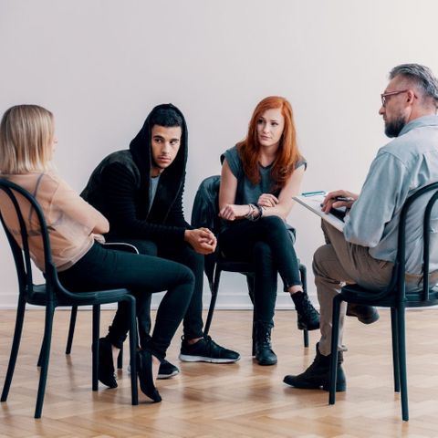 woman speaking in group therapy