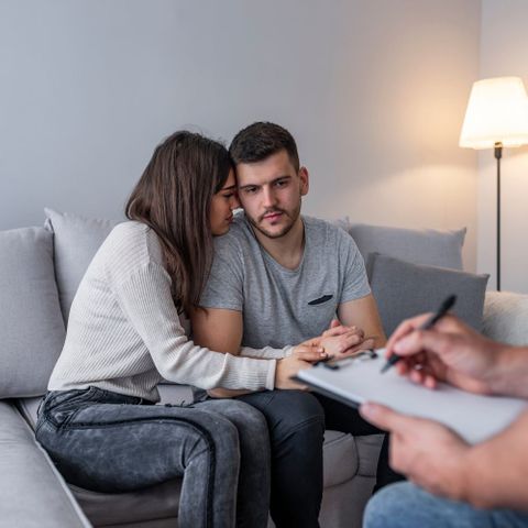 woman hugging husband in therapy