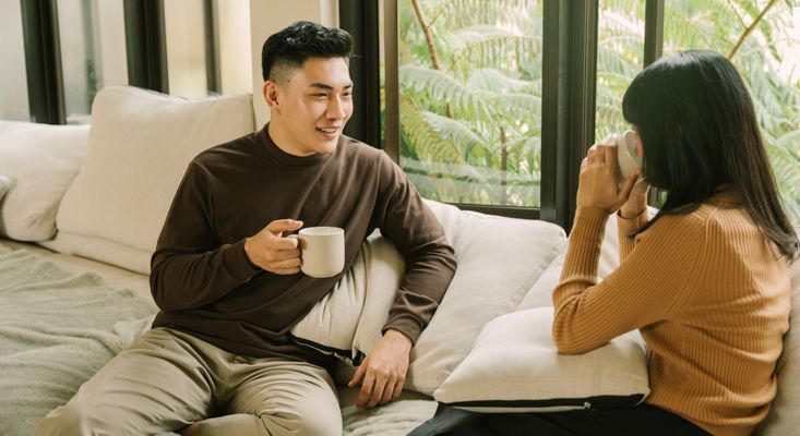 Two people talking over coffee