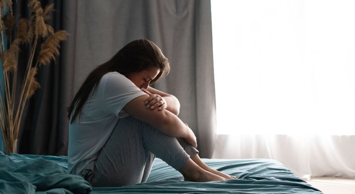woman with a mood disorder sitting in bed