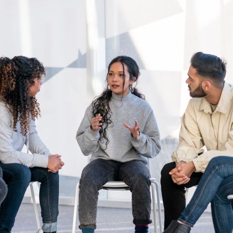 woman speaking in group therapy session