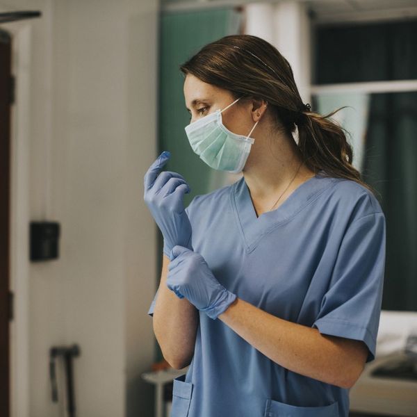 nurse putting gloves on